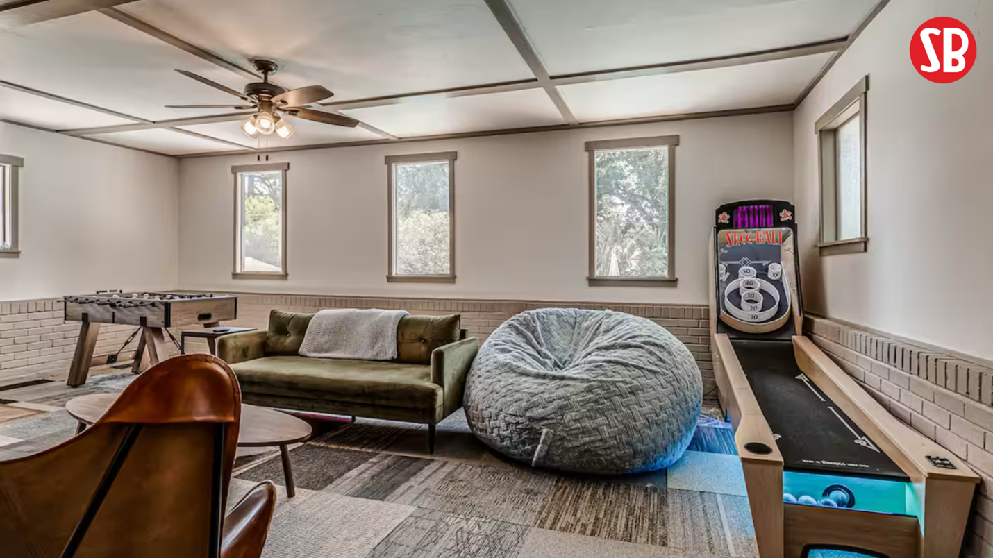 basement game room with Skee-Ball machine