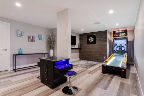 basement game room with Skee-Ball machine