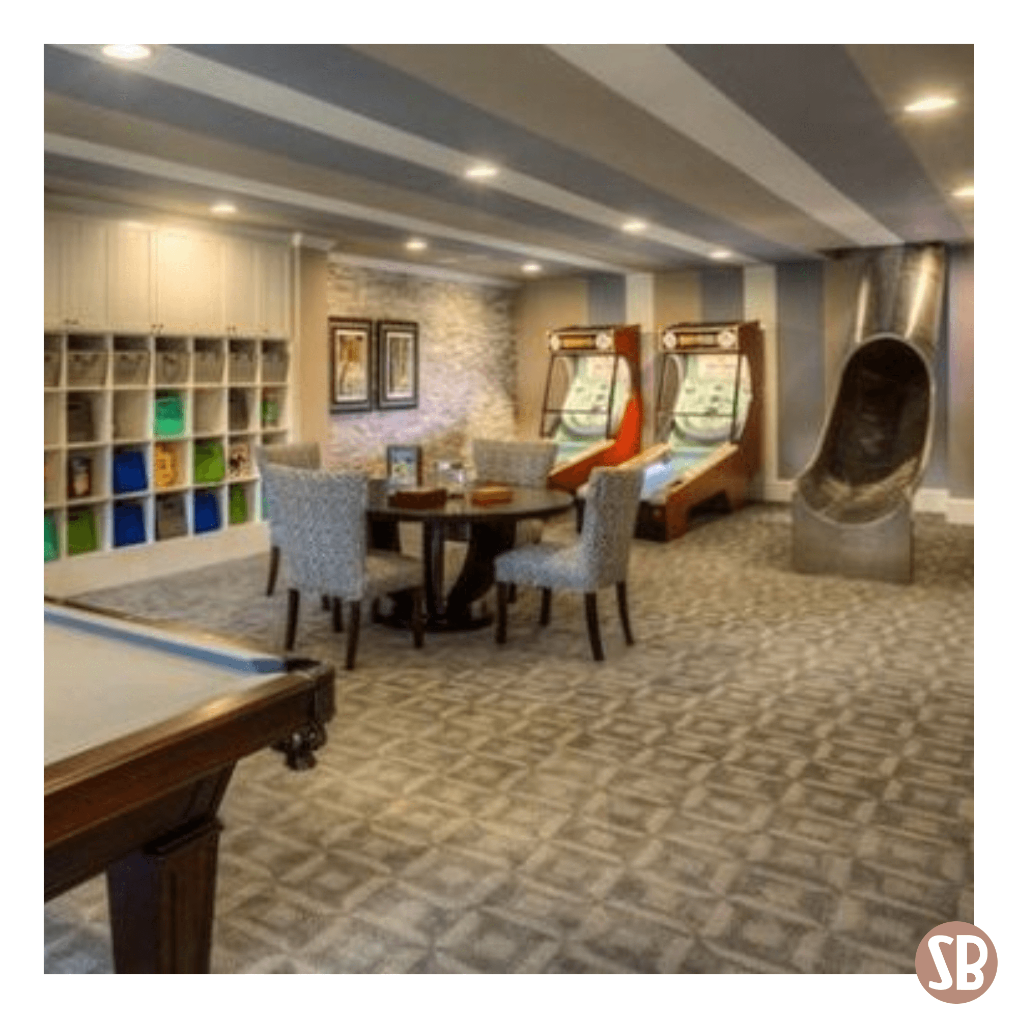 A basement featuring two Skee-Ball Home Alley machines and a slide