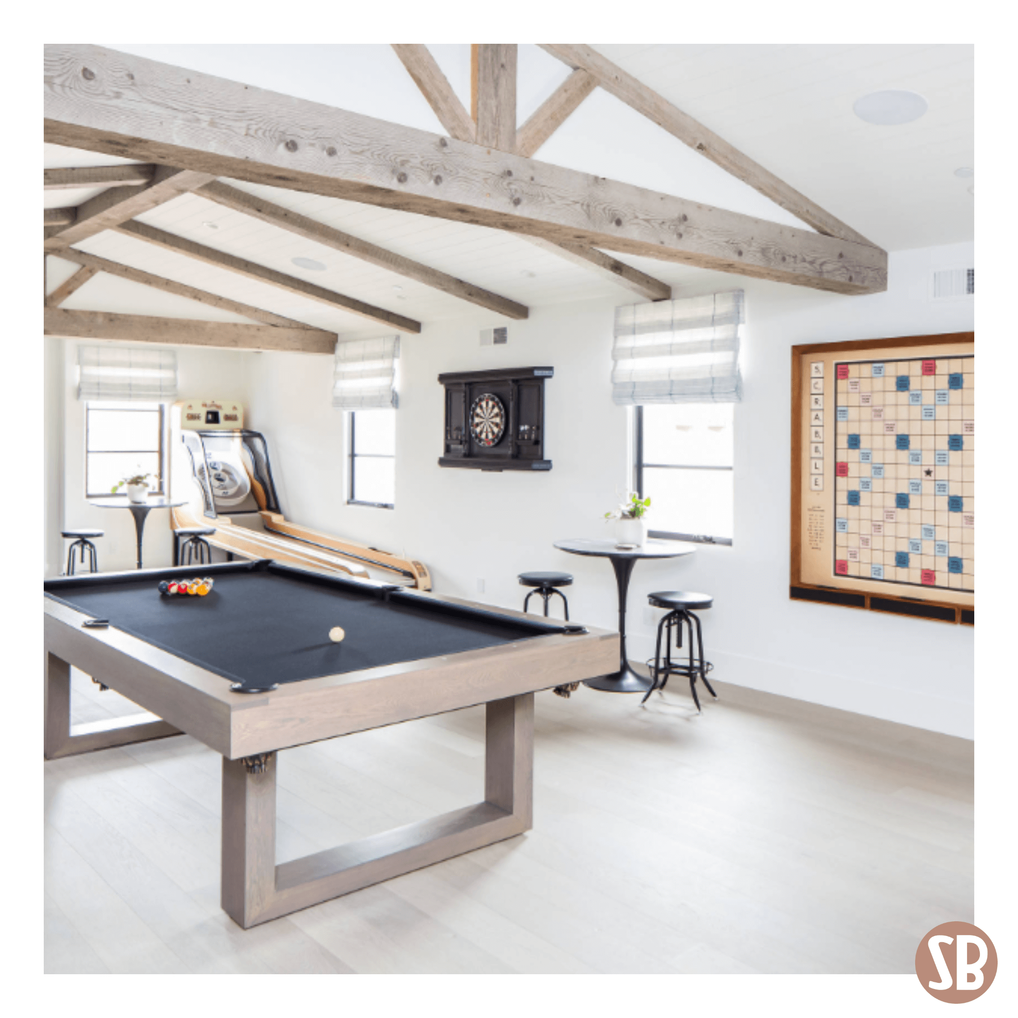 A farm house room design featuring a dart board, Scrabble table and a Skee-Ball Home Alley machine