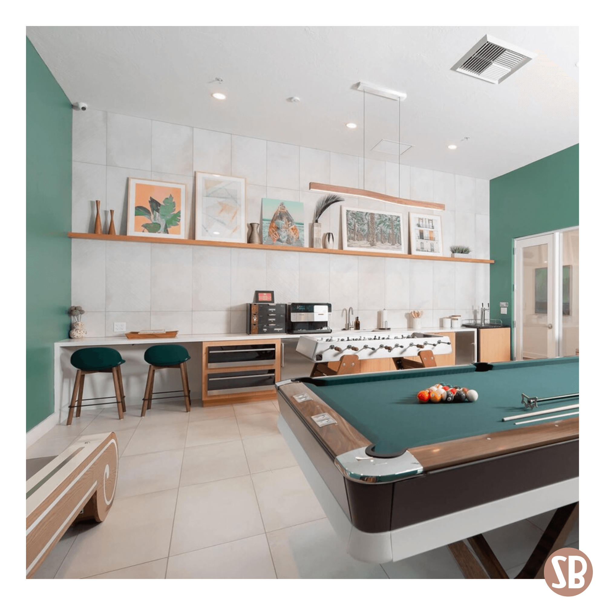 A modern room design featuring a pool table and a Skee-Ball Home Alley machine