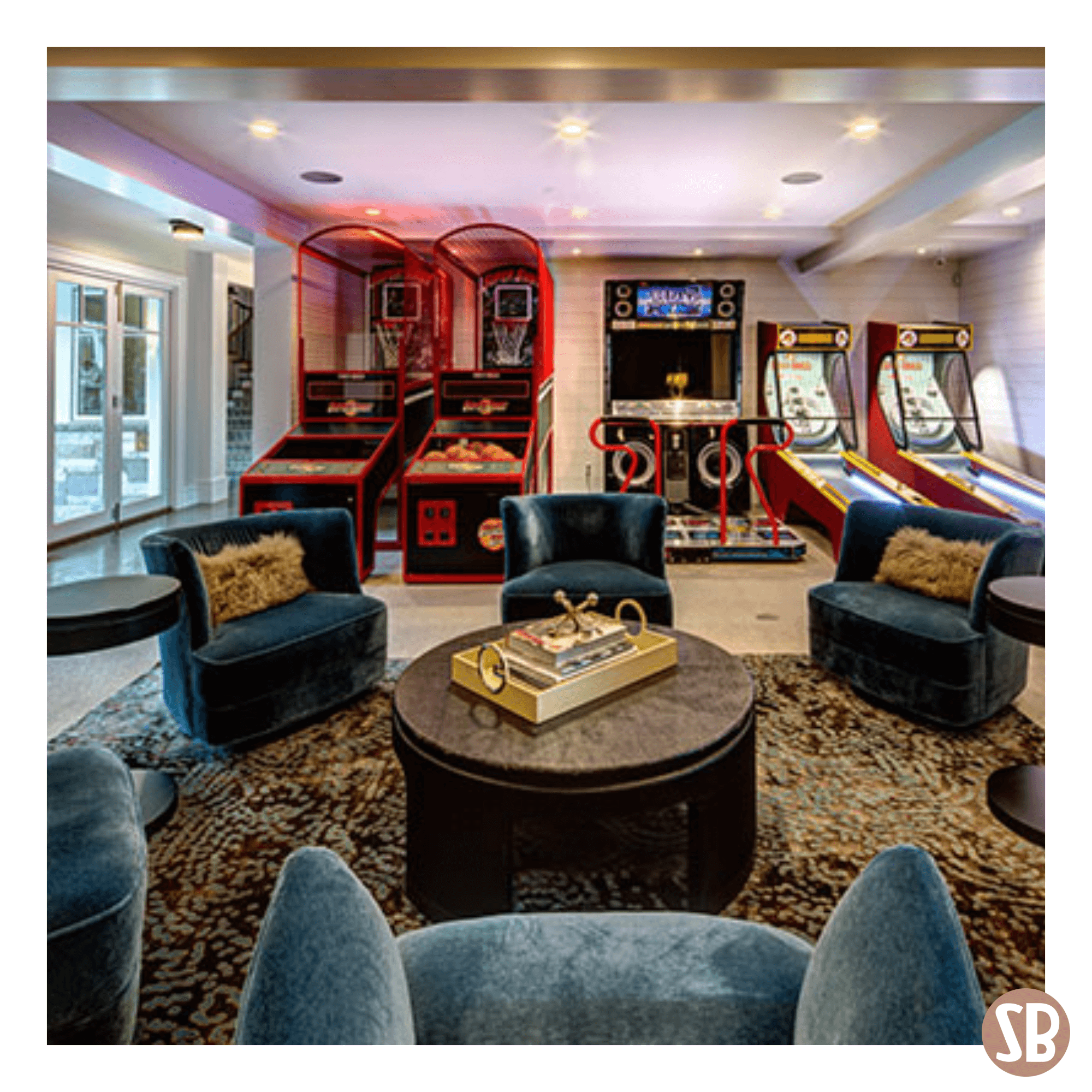 Two Skee-Ball Home Alley machines in a basement entertainment room featuring Pop-A-Shot and a dance machine