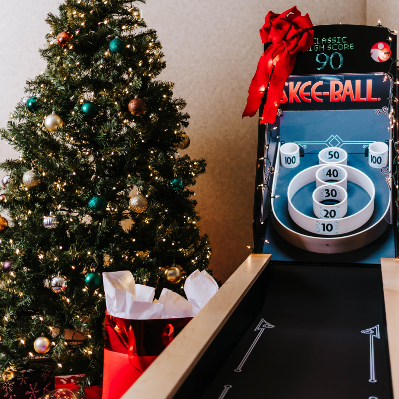 Skee-Ball Home Arcade Alley next to Christmas tree